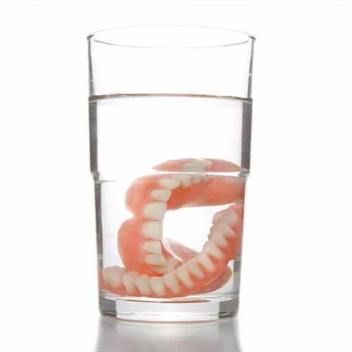 dentures in glass of water