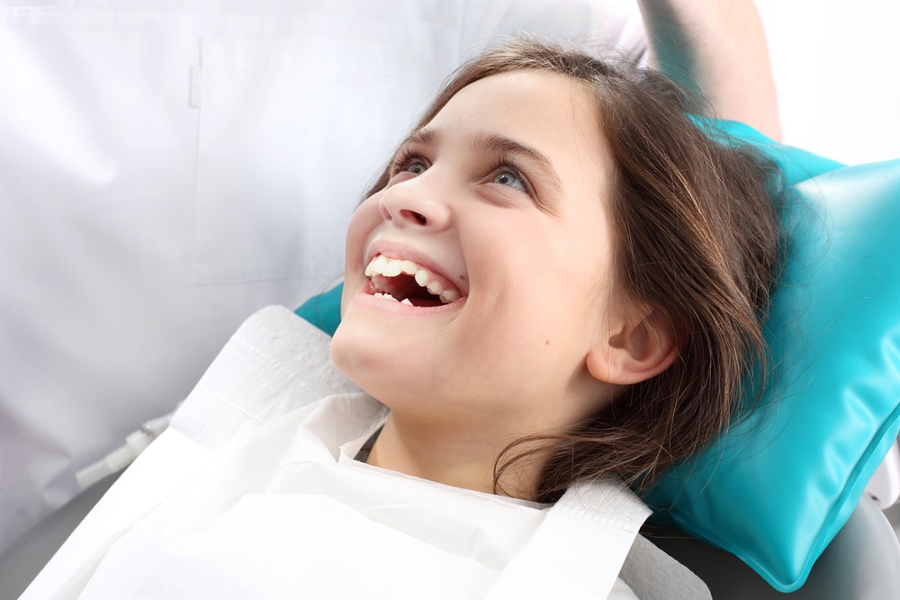 Smiling girl with in dentist's chair