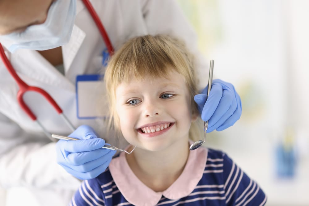 little girl smiling at dentist office