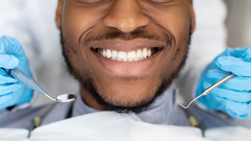 Close-up of smiling mouth of man at dentist
