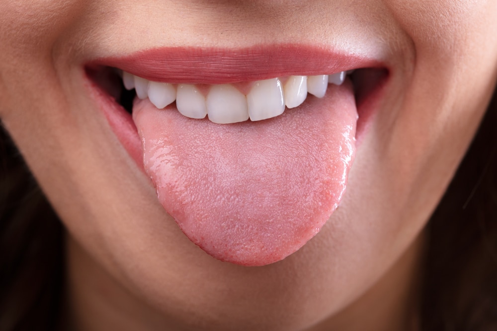 Close-up of woman sticking out tongue